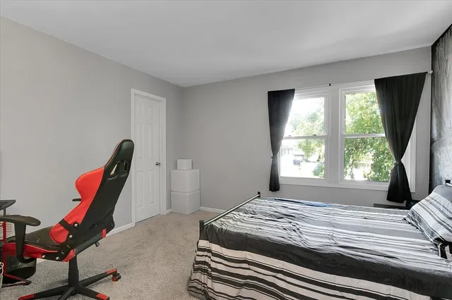 a spacious bedroom with a bed and a window