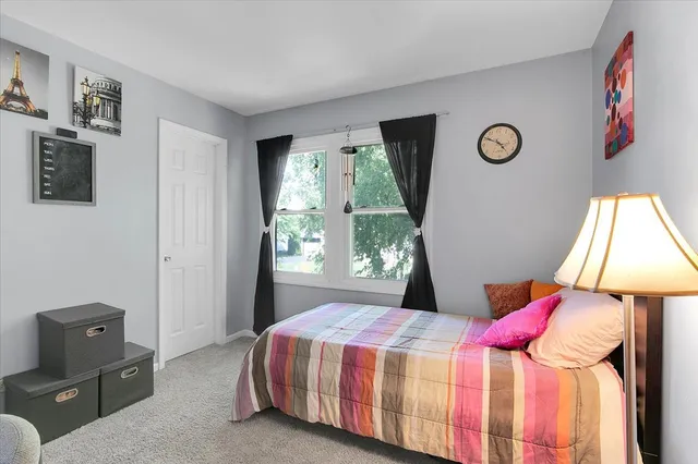 a bedroom with a bed and a dresser
