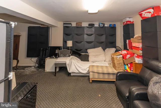 a bedroom with a bed furniture and a large mirror