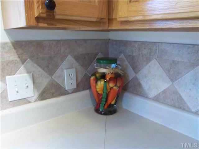 1003 Delham Road Knightdale, NC 27545 - Photo 8 of 18 Notice the beautiful tile backsplash in the kitchen