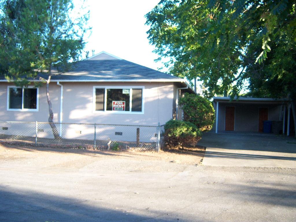 10237 University Way Cupertino, CA 95014 - Photo 2 of 12 a front view of a house with a yard