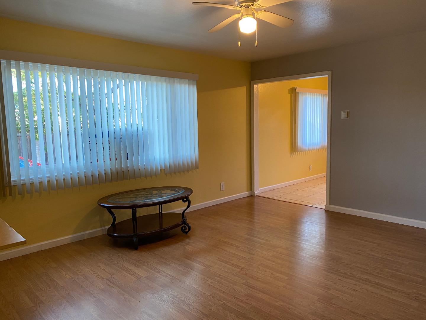 10237 University Way Cupertino, CA 95014 - Photo 4 of 12 an empty room with wooden floor and windows
