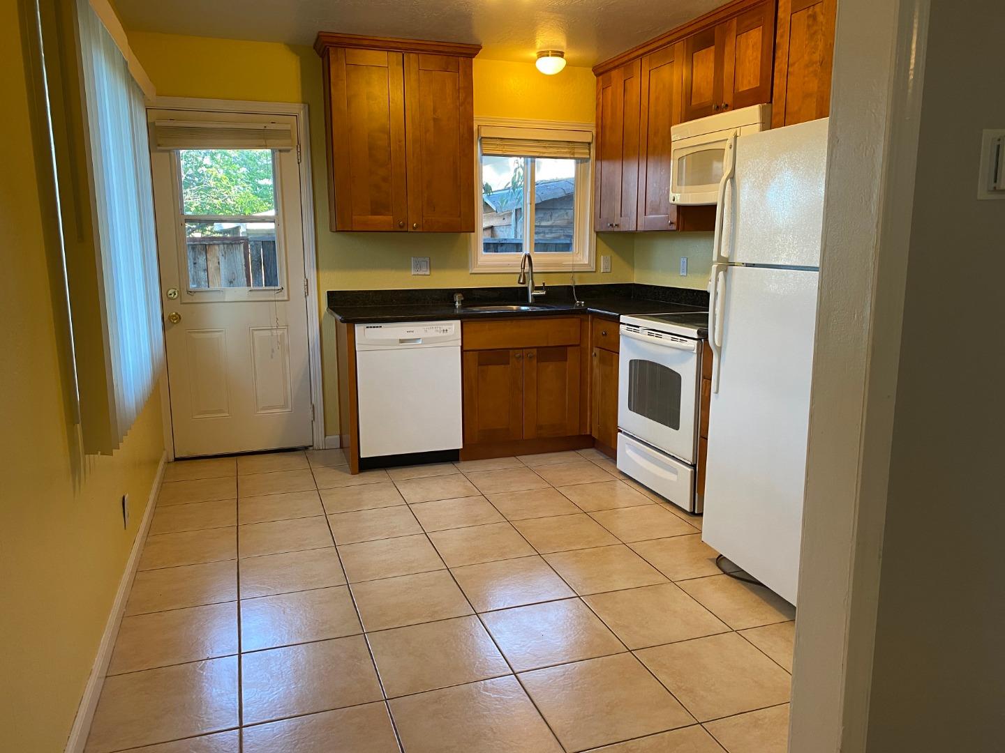 10237 University Way Cupertino, CA 95014 - Photo 5 of 12 a kitchen with a stove a refrigerator and a sink