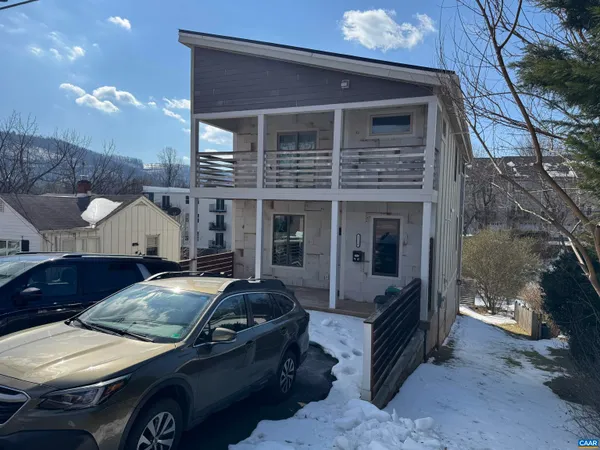 a view of a car parked in front of a house