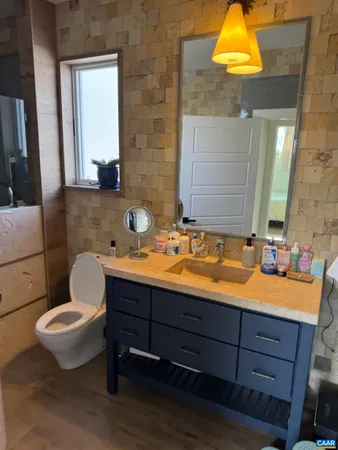 a bathroom with a toilet sink and mirror