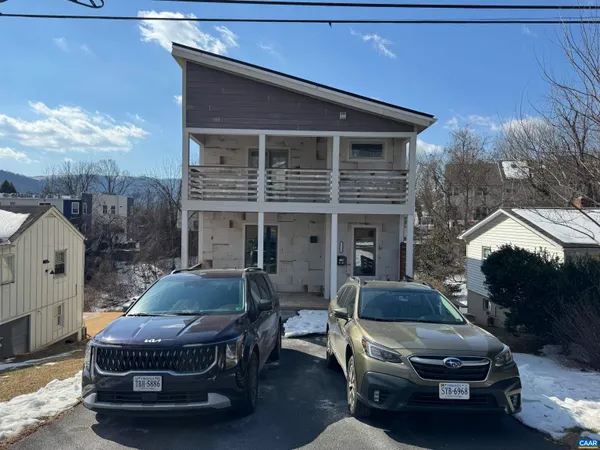 a front view of house with car parked
