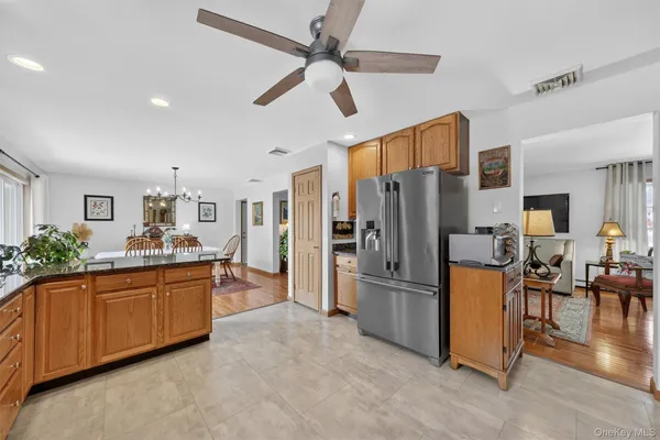 a kitchen with stainless steel appliances granite countertop a refrigerator and a sink