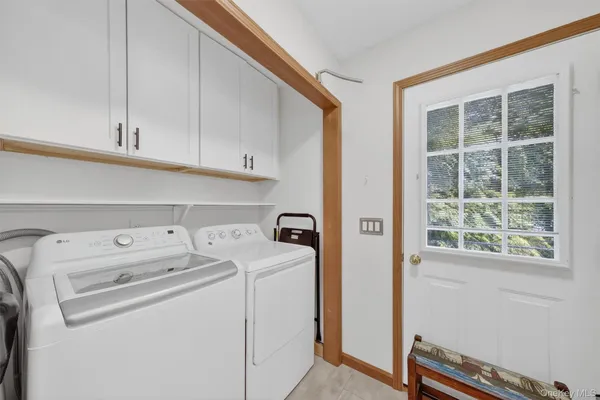 a view of storage and utility room with washer and dryer