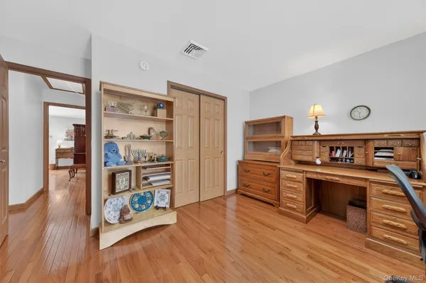 a kitchen with stainless steel appliances wooden floor and a refrigerator