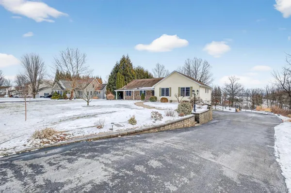 a view of house with outdoor space and sitting area