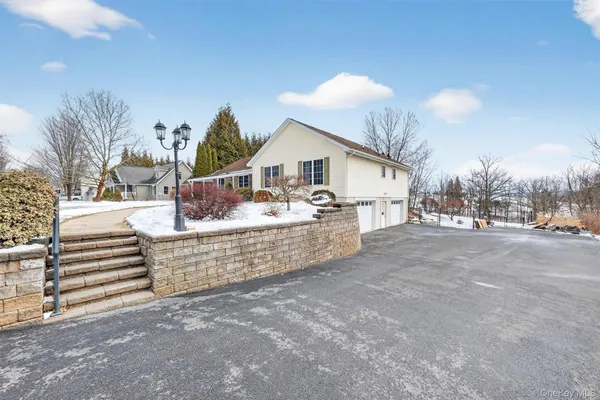 a view of a house with a patio and a yard