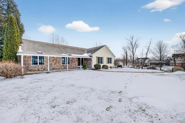 a front view of house with a garden and trees