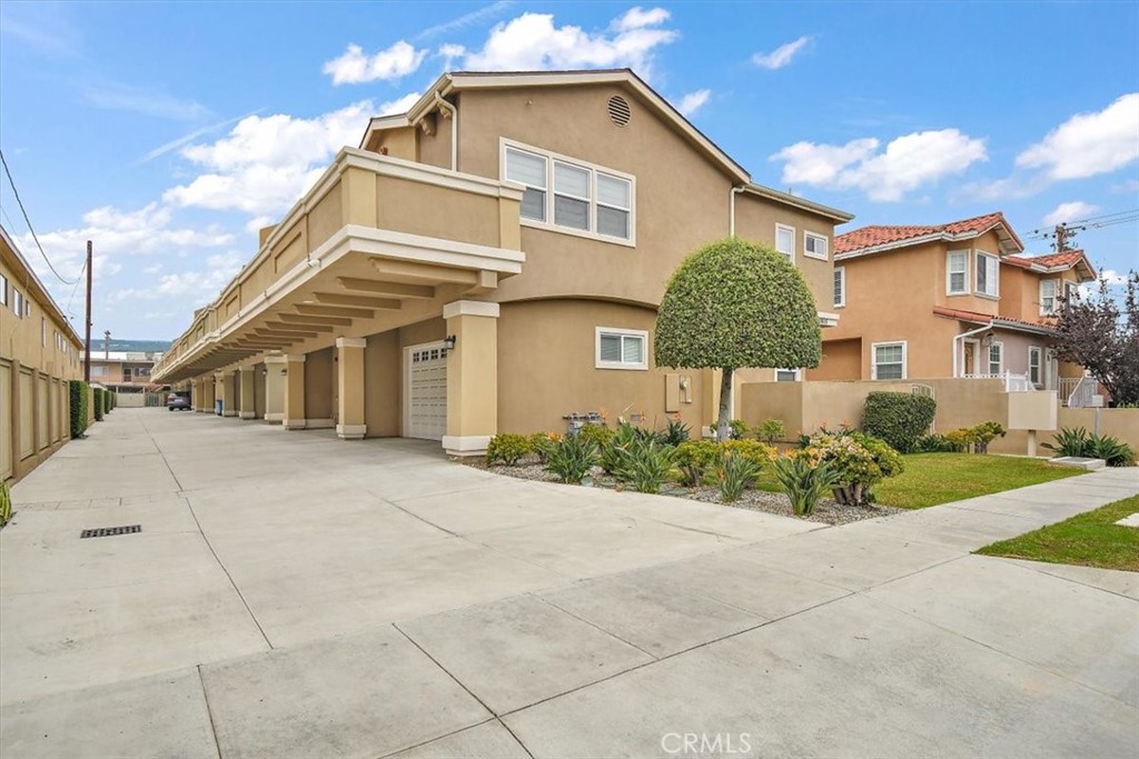 a view of a white house with a yard and plants