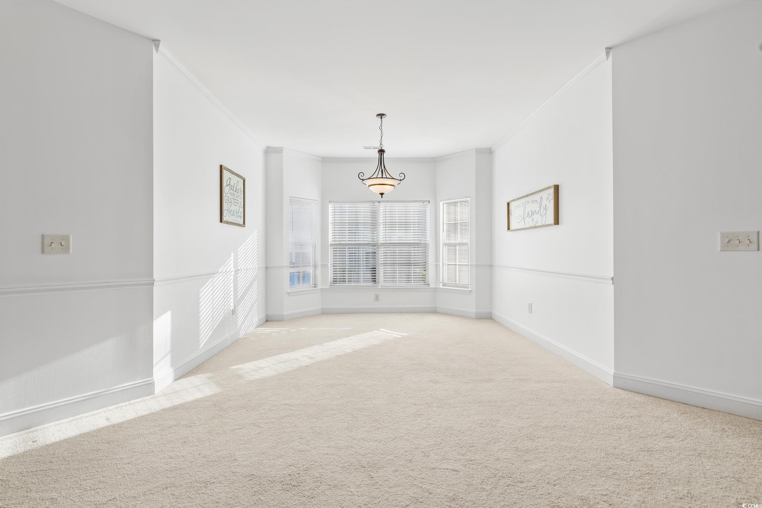 673 Botany Loop, Unit 673 Murrells Inlet, SC 29576 - Photo 13 of 39 Empty room featuring light carpet and crown moldin
