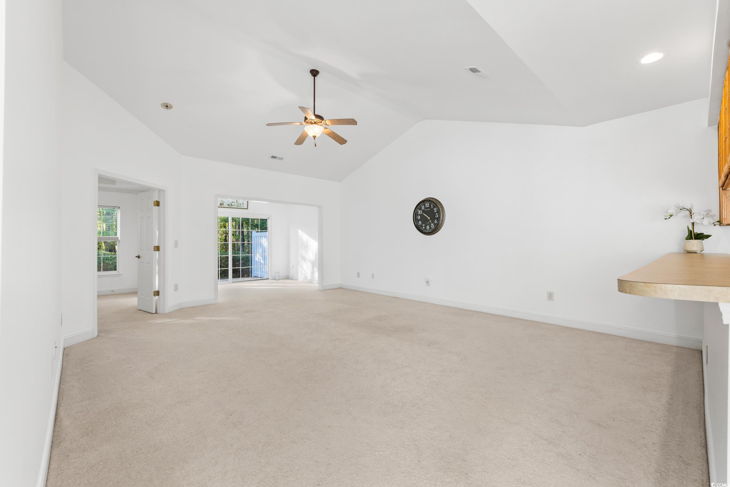 673 Botany Loop, Unit 673 Murrells Inlet, SC 29576 - Photo 21 of 39 Unfurnished living room with vaulted ceiling, ligh