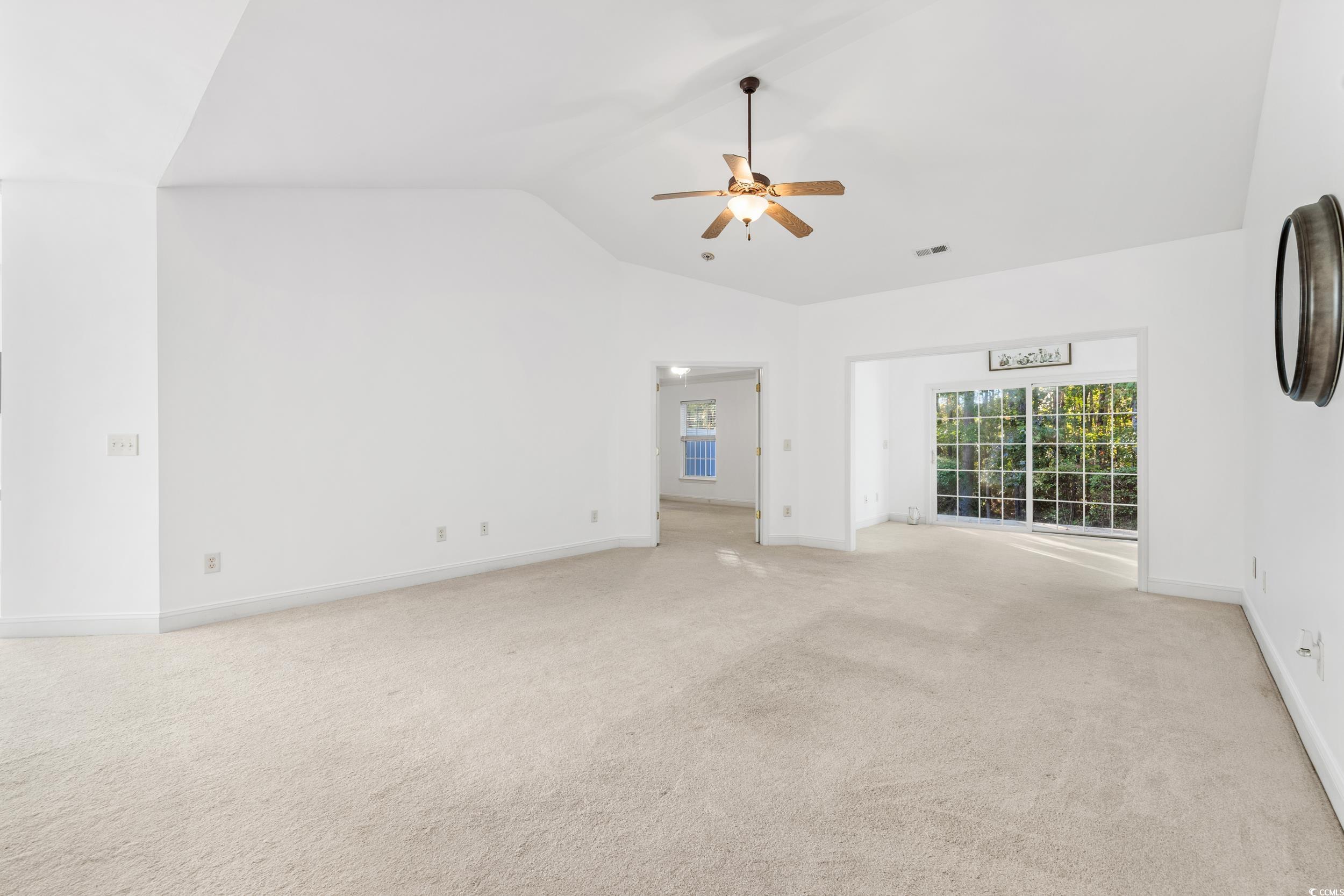 673 Botany Loop, Unit 673 Murrells Inlet, SC 29576 - Photo 22 of 39 Unfurnished living room with light carpet, high va