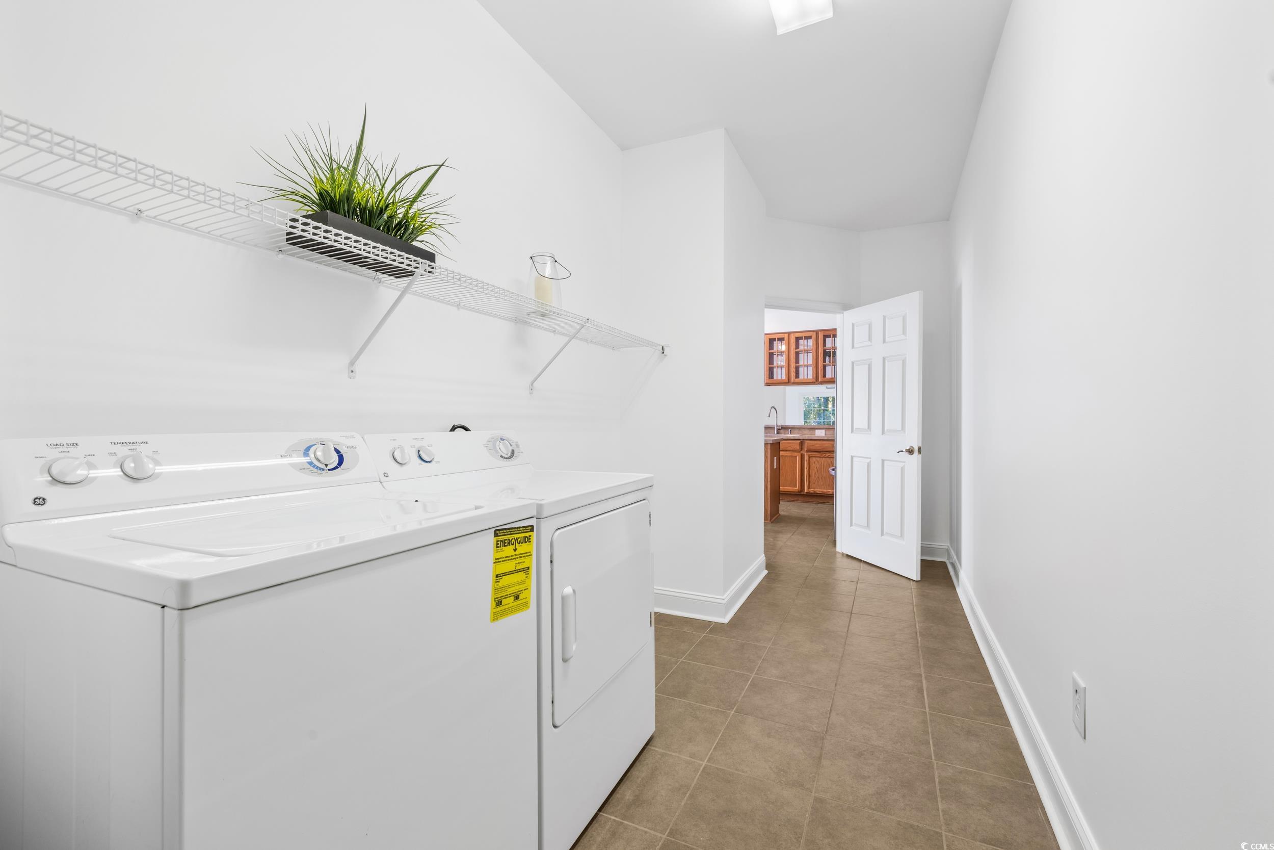 673 Botany Loop, Unit 673 Murrells Inlet, SC 29576 - Photo 25 of 39 Laundry area with washer and dryer and light tile