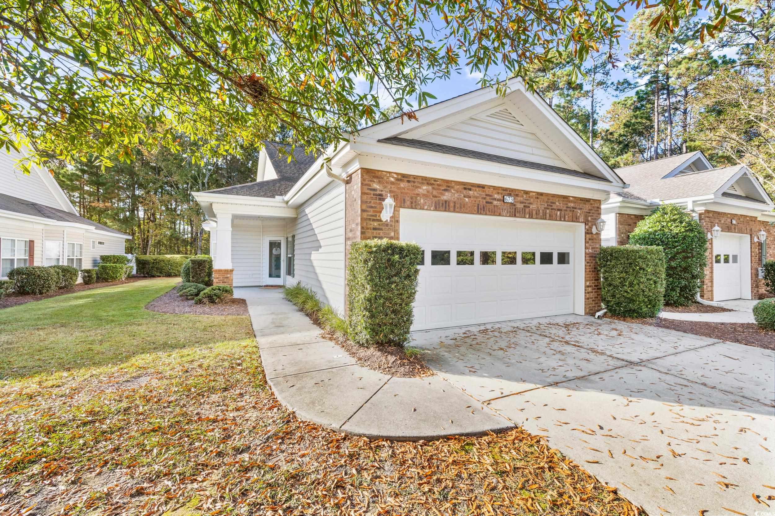 673 Botany Loop, Unit 673 Murrells Inlet, SC 29576 - Photo 4 of 39 View of front of house with a front yard and a gar