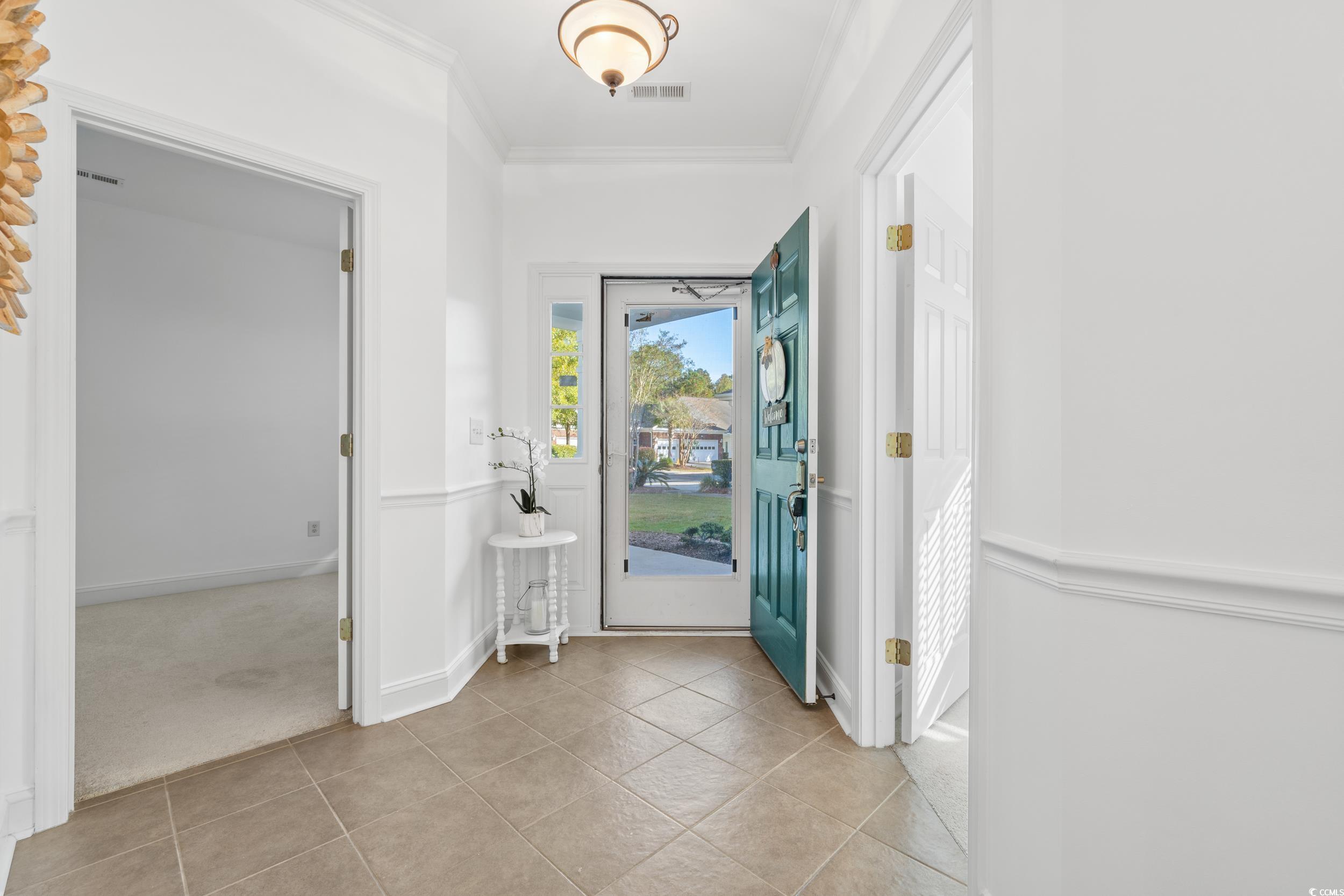 673 Botany Loop, Unit 673 Murrells Inlet, SC 29576 - Photo 7 of 39 Doorway to outside featuring light carpet and crow