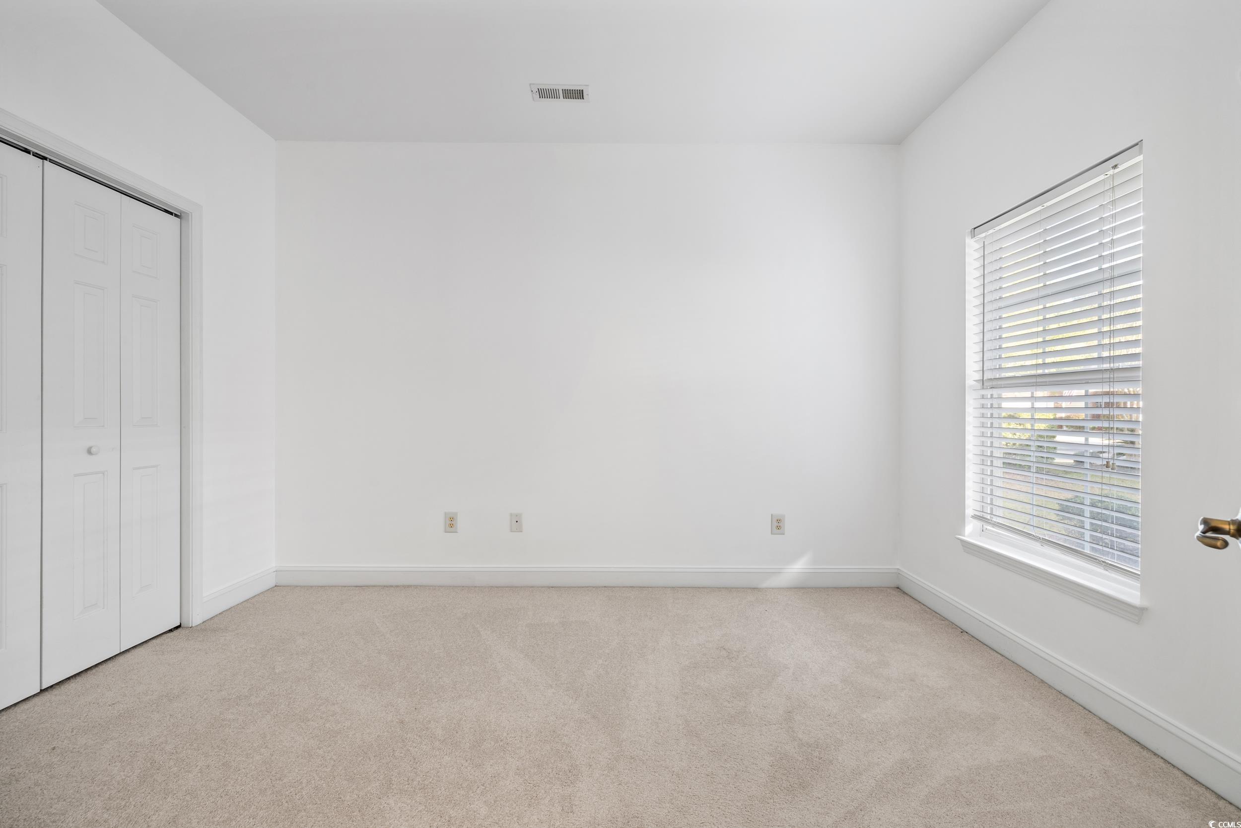 673 Botany Loop, Unit 673 Murrells Inlet, SC 29576 - Photo 8 of 39 Unfurnished bedroom with light carpet