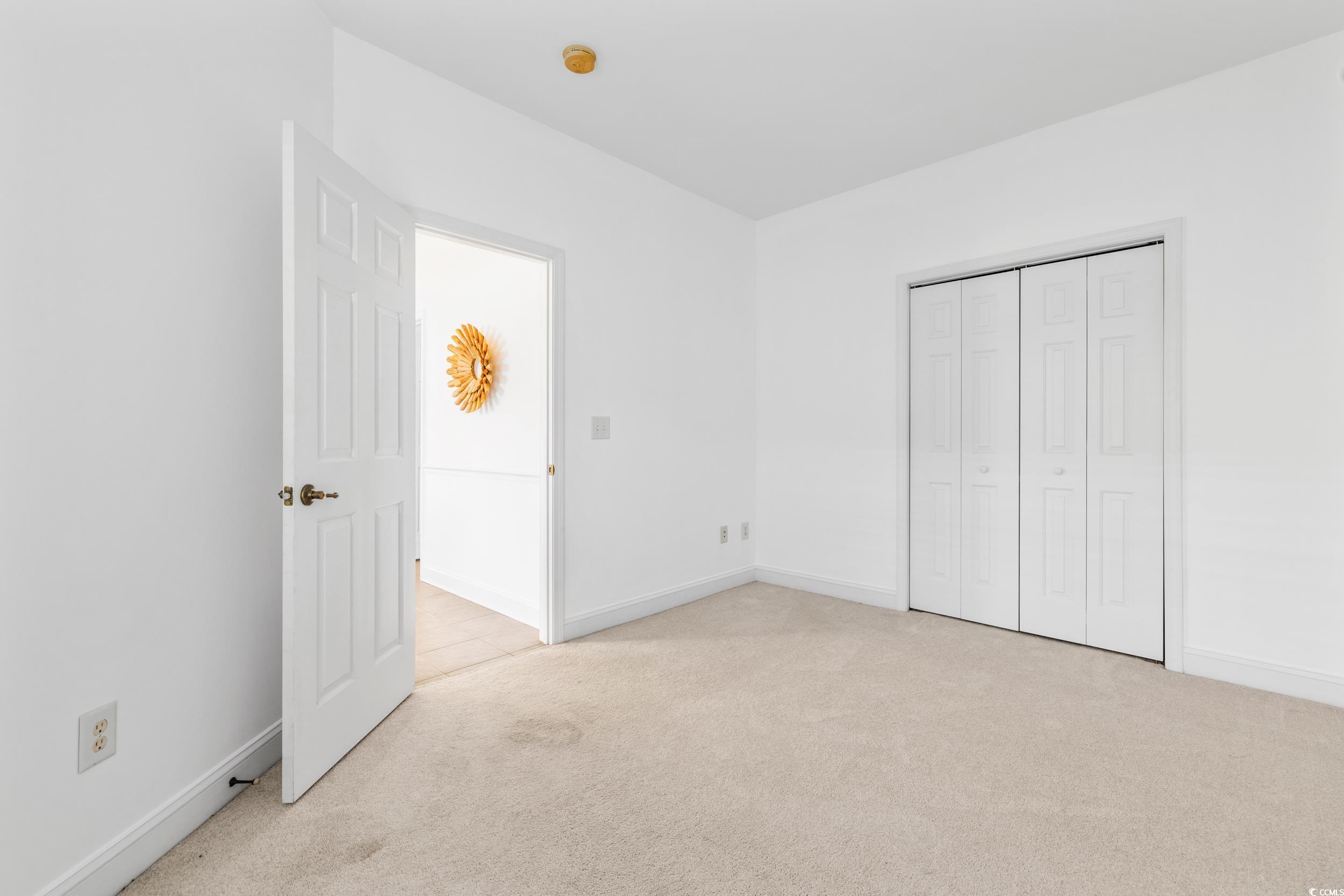 673 Botany Loop, Unit 673 Murrells Inlet, SC 29576 - Photo 9 of 39 Unfurnished bedroom with light colored carpet and