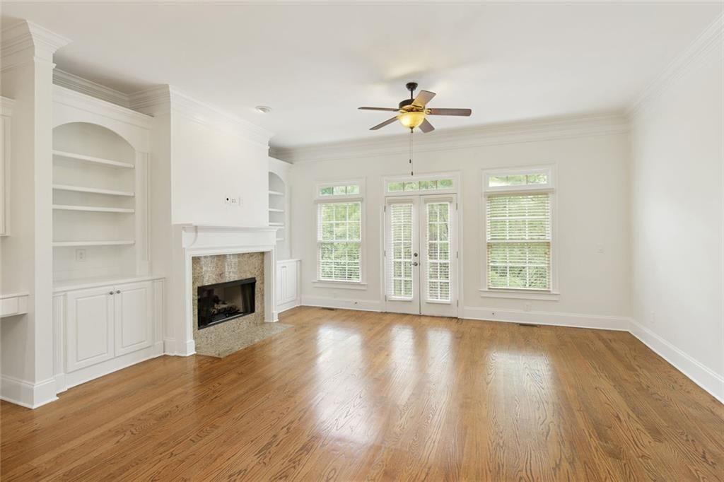 956 Persimmon Point Northeast Sandy Springs, GA 30328 - Photo 11 of 35 a view of an empty room with a fireplace and wooden floor