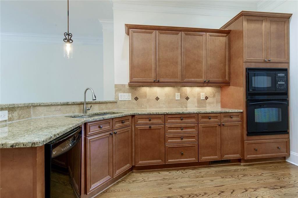 956 Persimmon Point Northeast Sandy Springs, GA 30328 - Photo 18 of 35 a kitchen with granite countertop a sink and cabinets