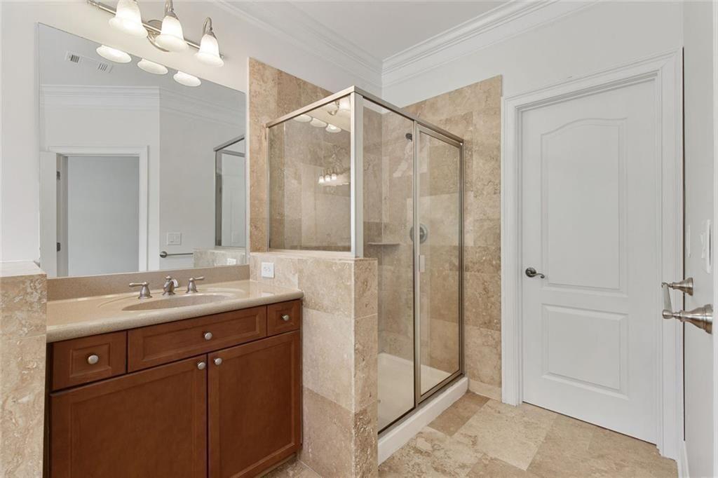 956 Persimmon Point Northeast Sandy Springs, GA 30328 - Photo 26 of 35 a bathroom with a granite countertop sink a mirror and a shower