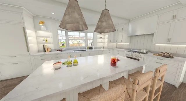a kitchen with stainless steel appliances granite countertop a sink a window and white cabinets