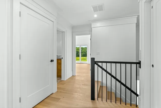 a view of hallway with wooden floor