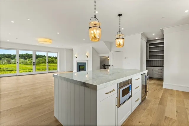a kitchen with a stove and a wooden floor