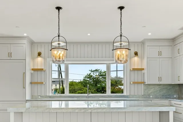 a view of a room with a chandelier and entryway