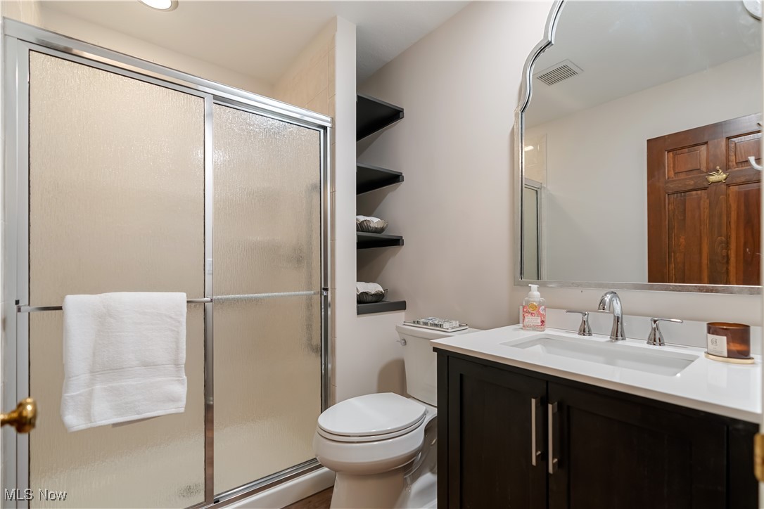 4124 Bramshaw Road Northwest Canton, OH 44718 - Photo 22 of 40 Bathroom with visible vents, a shower stall, toilet, and vanity