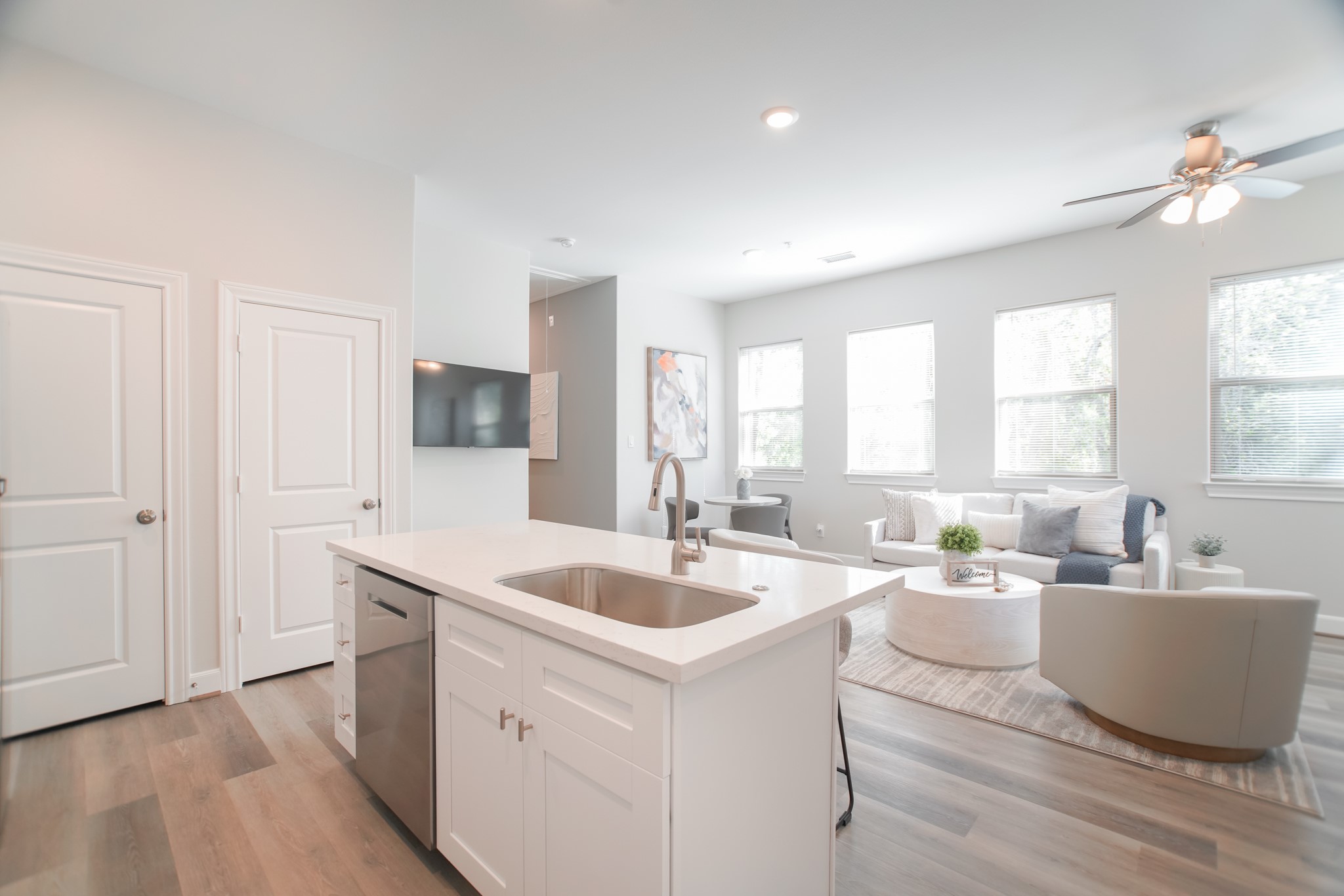 504 Nursery Road, Unit 3206 The Woodlands, TX 77380 - Photo 19 of 35 a living room with stainless steel appliances kitchen island hardwood floor sink and a window