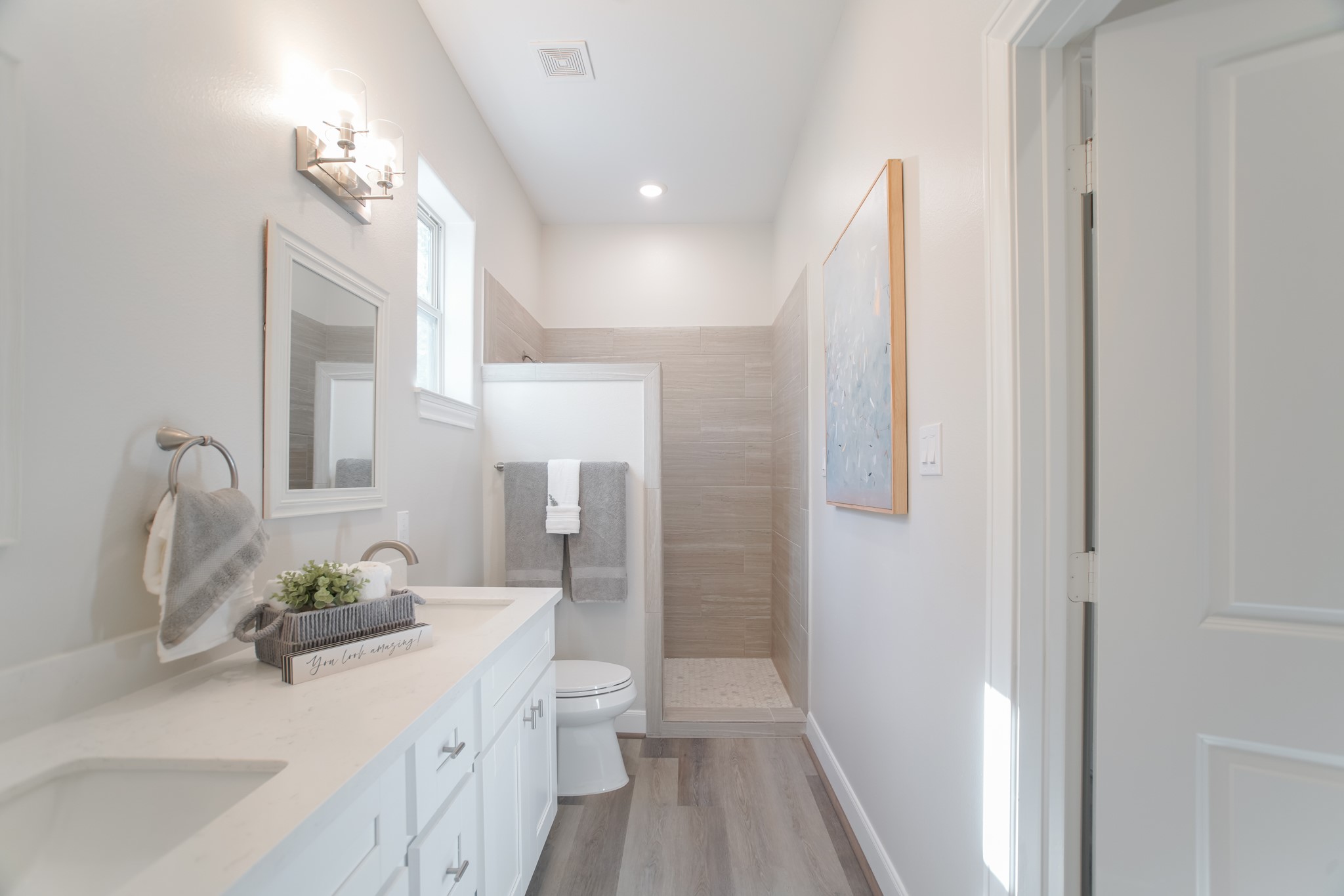 504 Nursery Road, Unit 3206 The Woodlands, TX 77380 - Photo 30 of 35 a bathroom with a sink a toilet and a large mirror