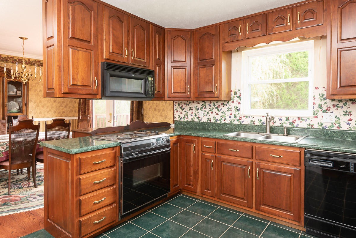 120 Cedar Road Clinton, TN 37716 - Photo 12 of 15 a kitchen with stainless steel appliances granite countertop a stove a sink and a microwave