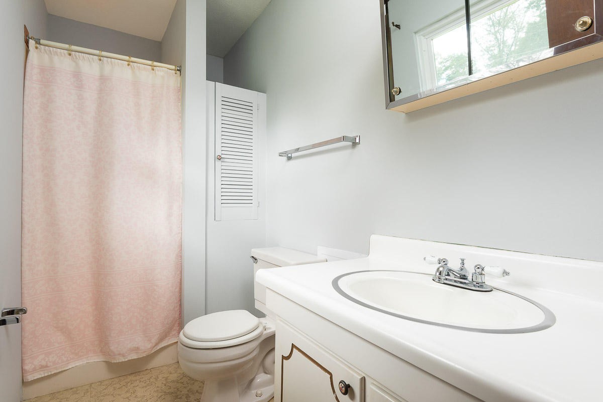 120 Cedar Road Clinton, TN 37716 - Photo 5 of 15 a bathroom with a sink toilet and a mirror