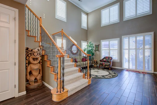 a living room with furniture ceiling fan and a window