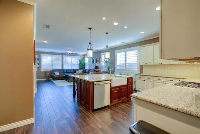 a living room with furniture a fireplace and a large window