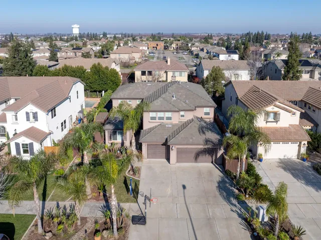 a front view of a house with a yard and a garage