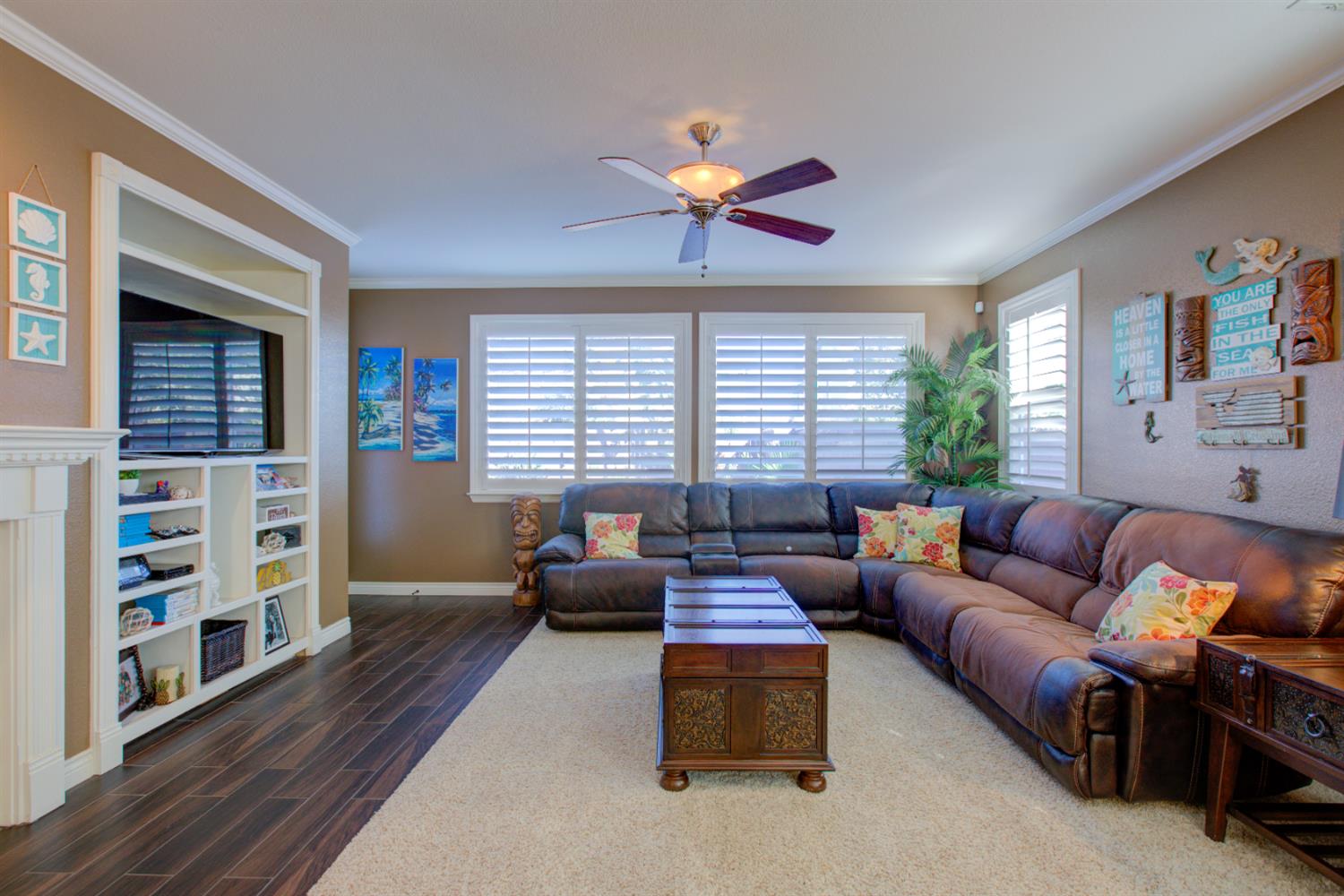 621 Bouma Lane Ripon, CA 95366 - Photo 38 of 78 a living room with furniture ceiling fan and a window