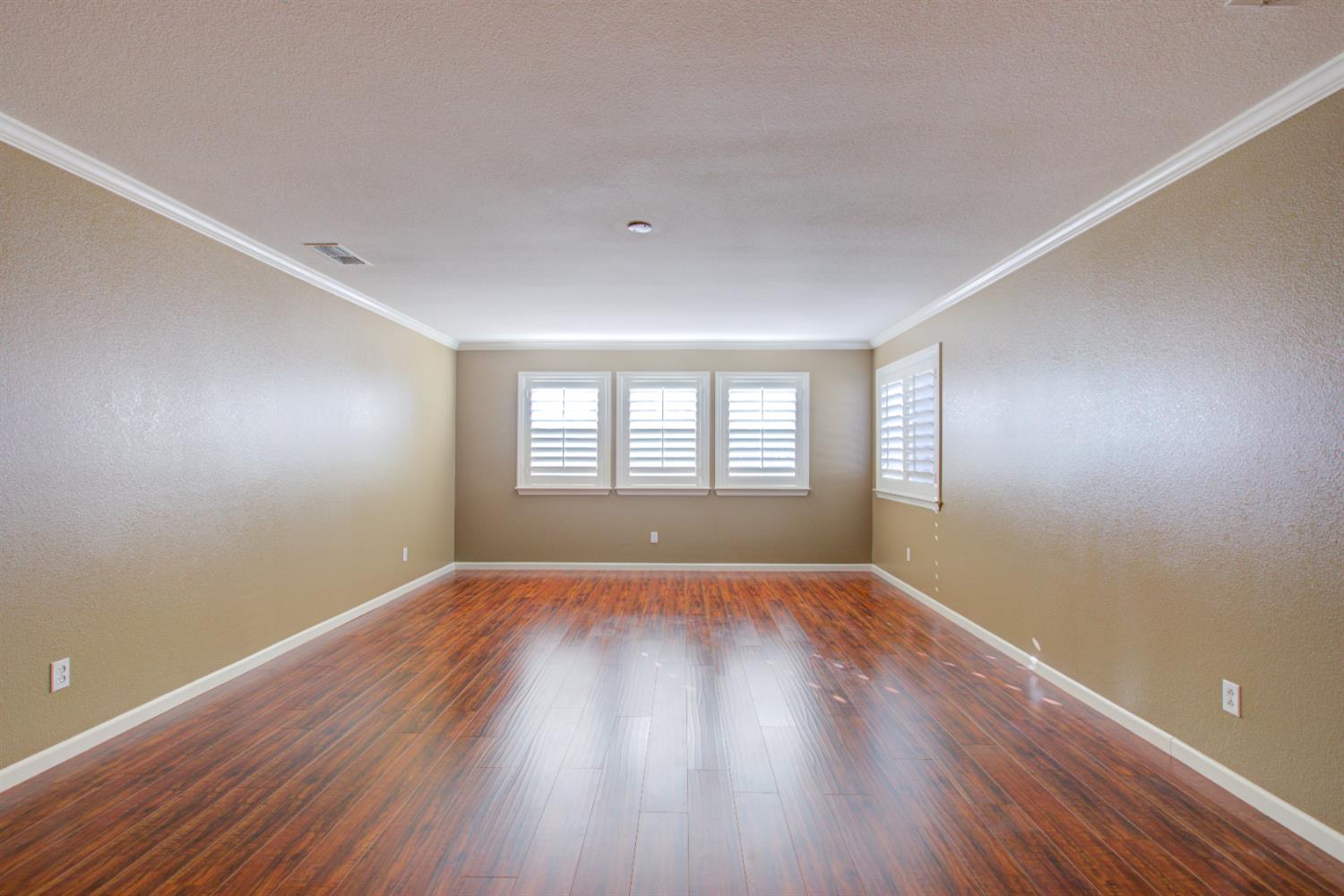 621 Bouma Lane Ripon, CA 95366 - Photo 53 of 78 an empty room with wooden floor and windows