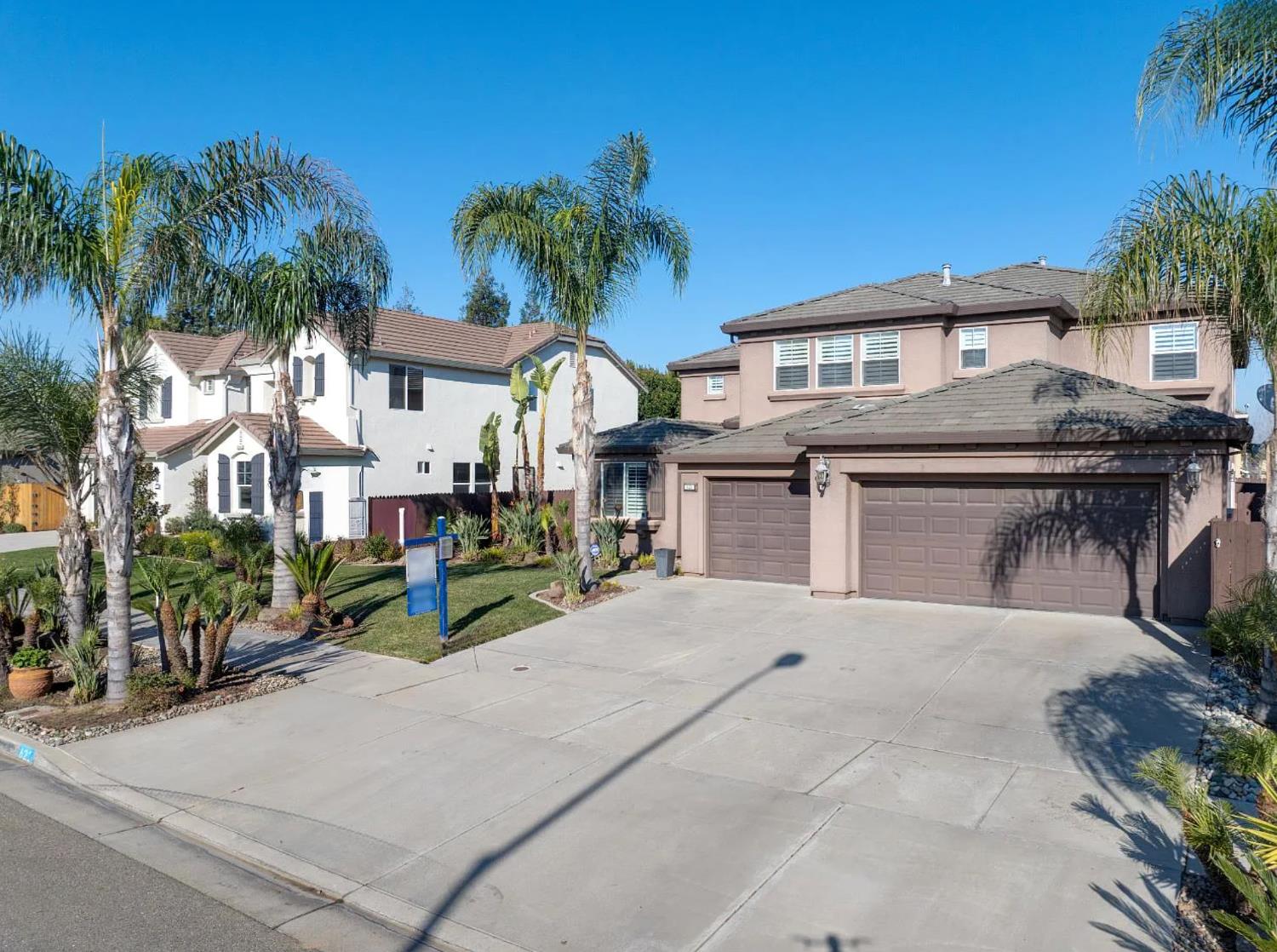 621 Bouma Lane Ripon, CA 95366 - Photo 6 of 78 a front view of a house with a yard and a garage