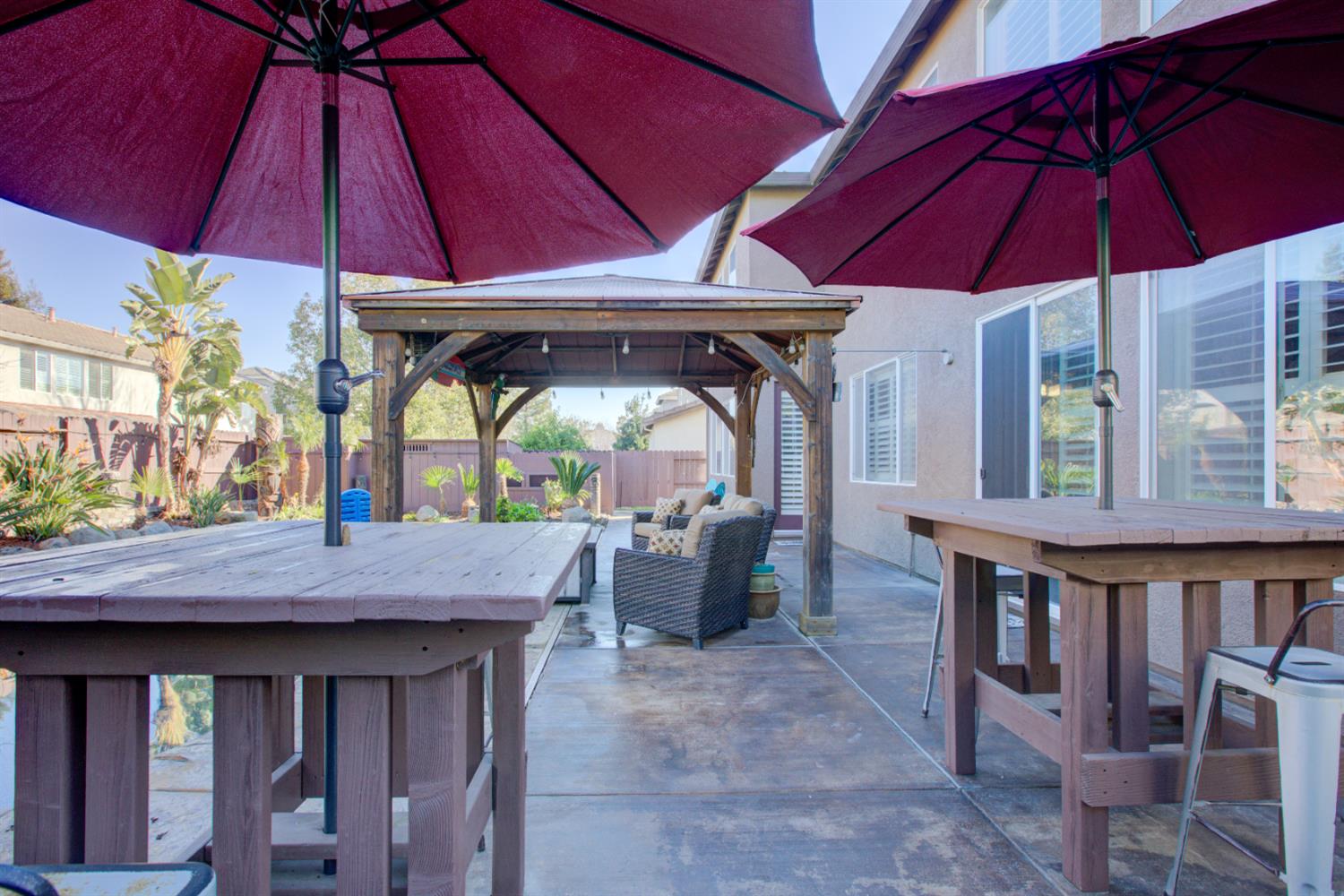 621 Bouma Lane Ripon, CA 95366 - Photo 76 of 78 a view of a patio with a table and chairs under an umbrella