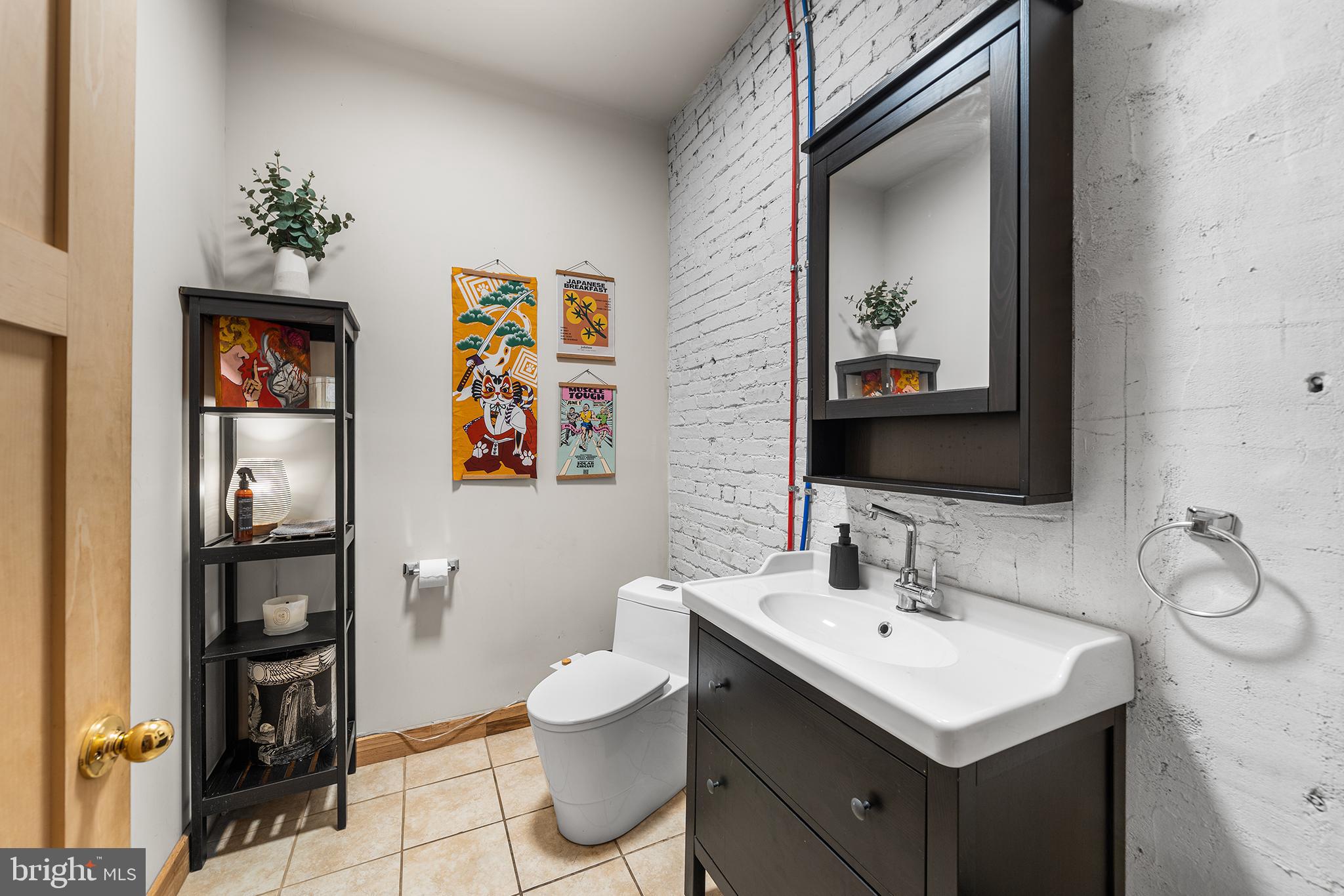 1506 East Wilt Street Philadelphia, PA 19125 - Photo 19 of 50 a bathroom with a toilet sink and mirror