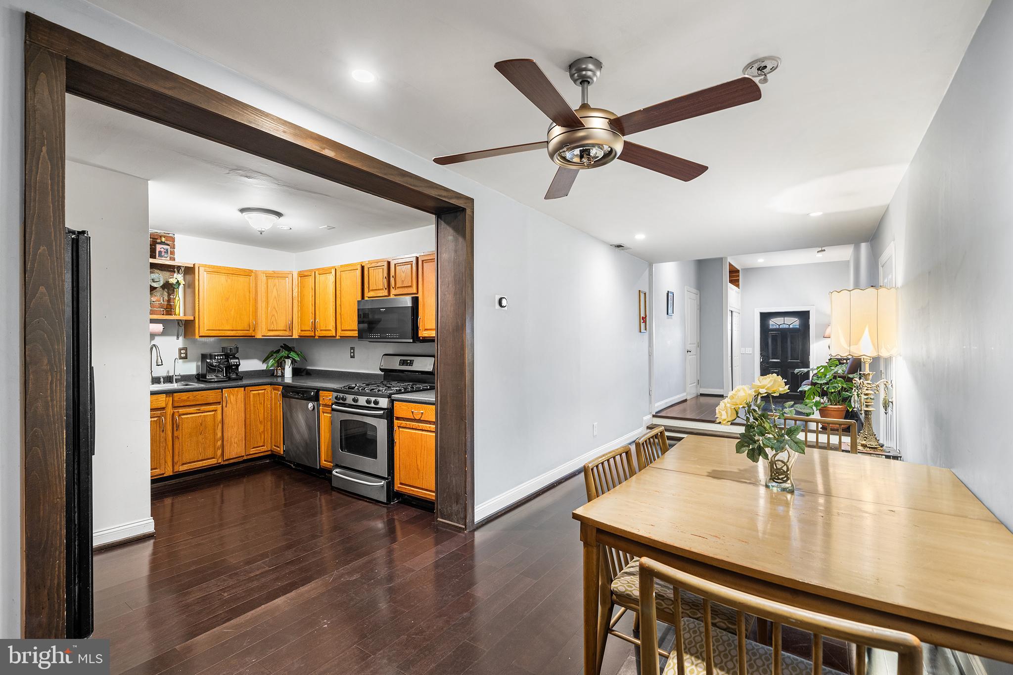1506 East Wilt Street Philadelphia, PA 19125 - Photo 25 of 50 a kitchen with stainless steel appliances granite countertop a refrigerator a sink dishwasher a stove and a dining table with wooden floor