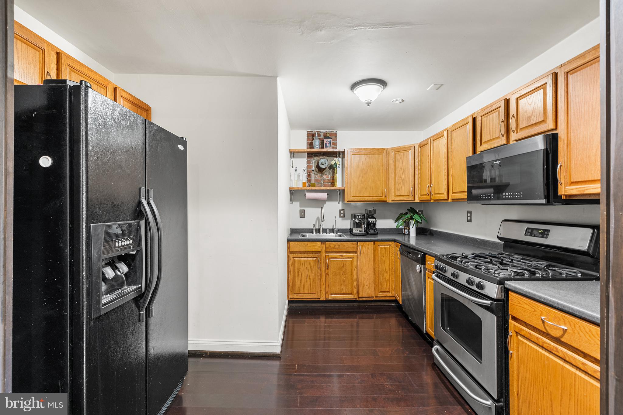 1506 East Wilt Street Philadelphia, PA 19125 - Photo 27 of 50 a kitchen with stainless steel appliances granite countertop a refrigerator a stove top oven a sink and dishwasher