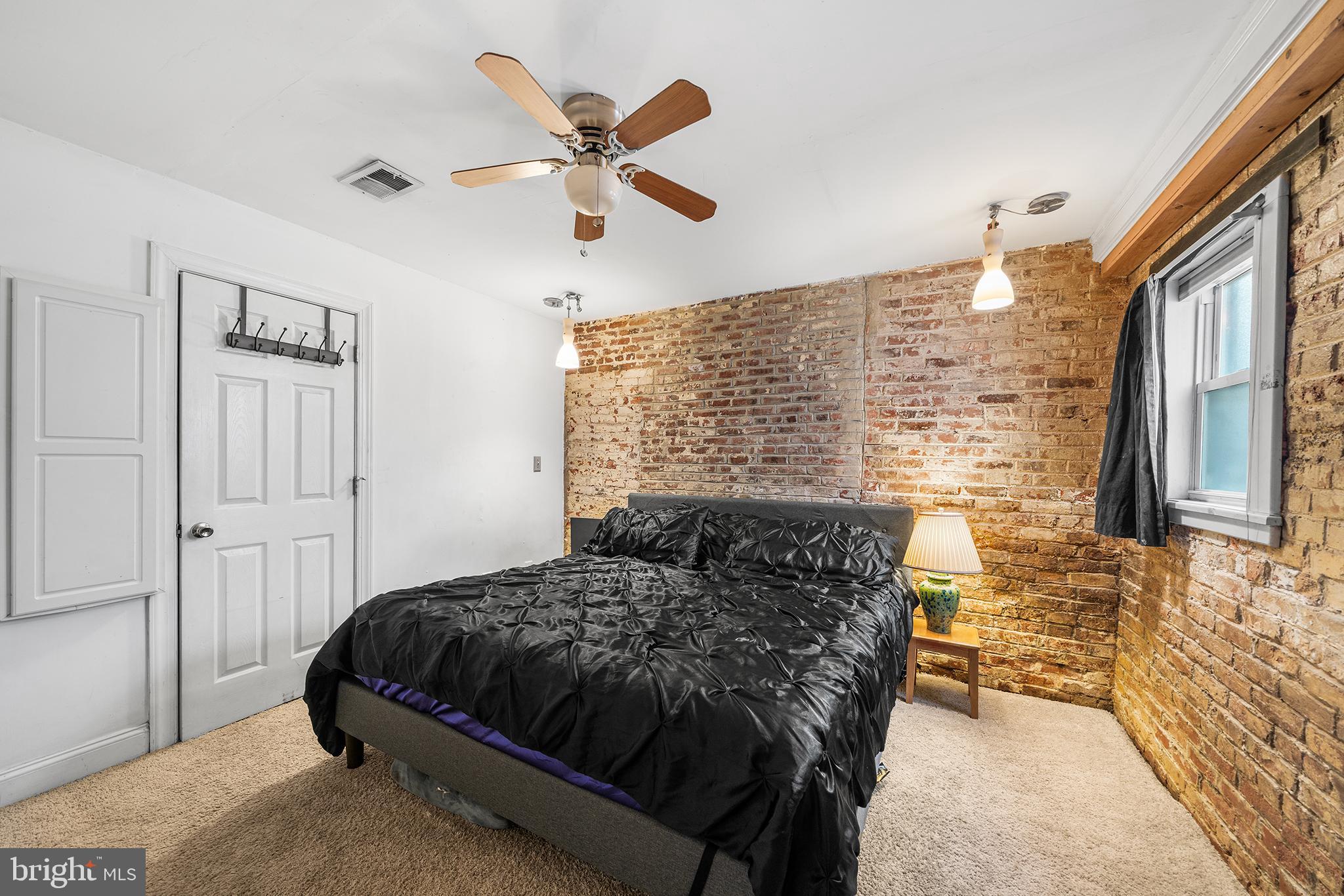 1506 East Wilt Street Philadelphia, PA 19125 - Photo 37 of 50 a bedroom with a bed and a chandelier