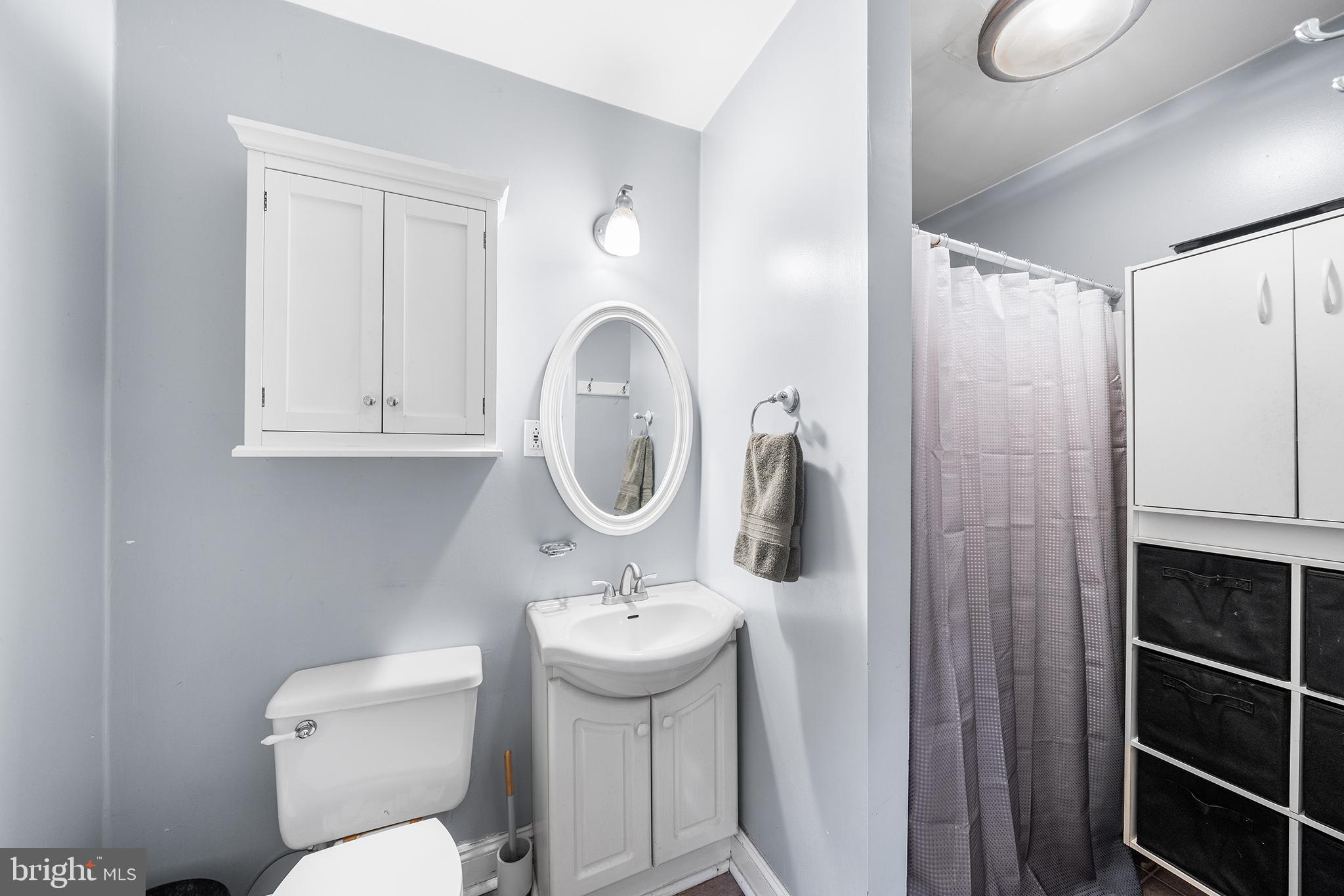 1506 East Wilt Street Philadelphia, PA 19125 - Photo 38 of 50 a bathroom with a sink a toilet and a mirror