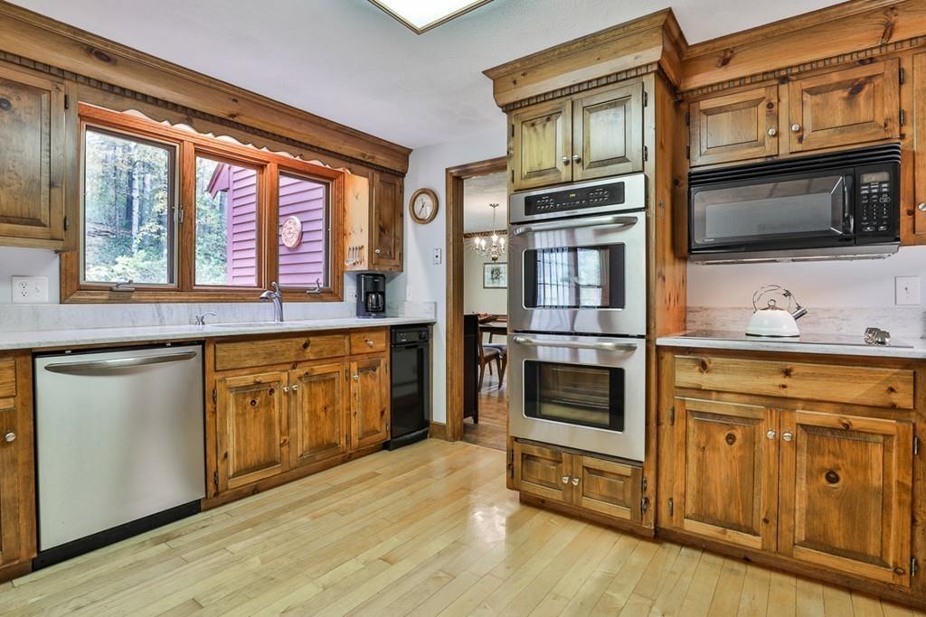 70 B Baldpate Road Boxford, MA 01921 - Photo 4 of 40 a kitchen with stainless steel appliances granite countertop a stove microwave and cabinets